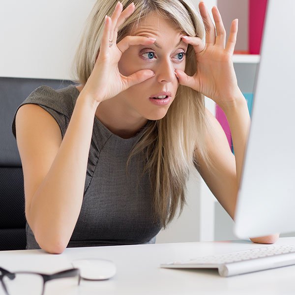 Person with strained eyes looking at computer